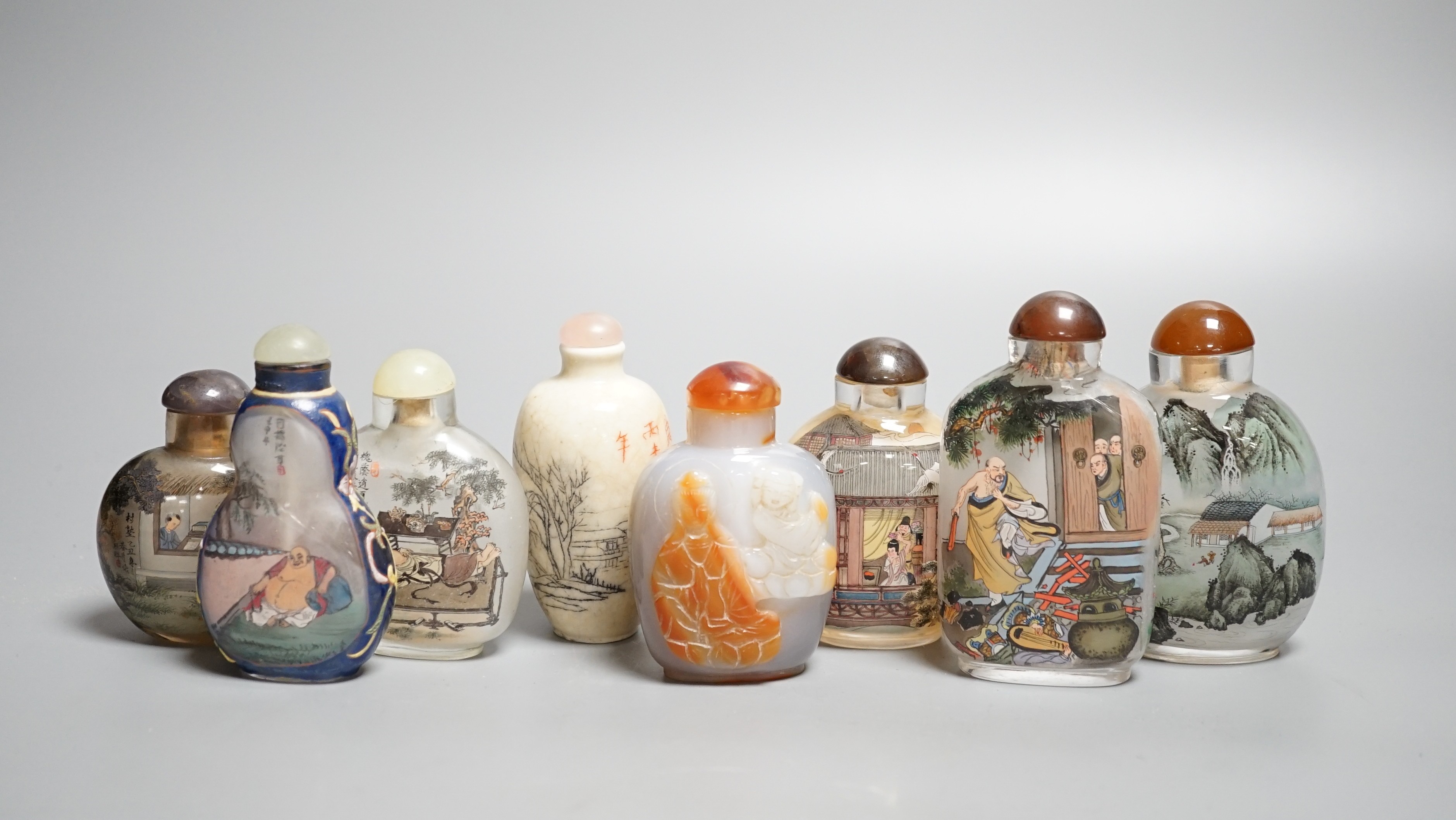 Six Chinese inside painted glass snuff bottles, an agate cameo snuff bottle and an incised crackle glaze snuff bottle, tallest 9cm